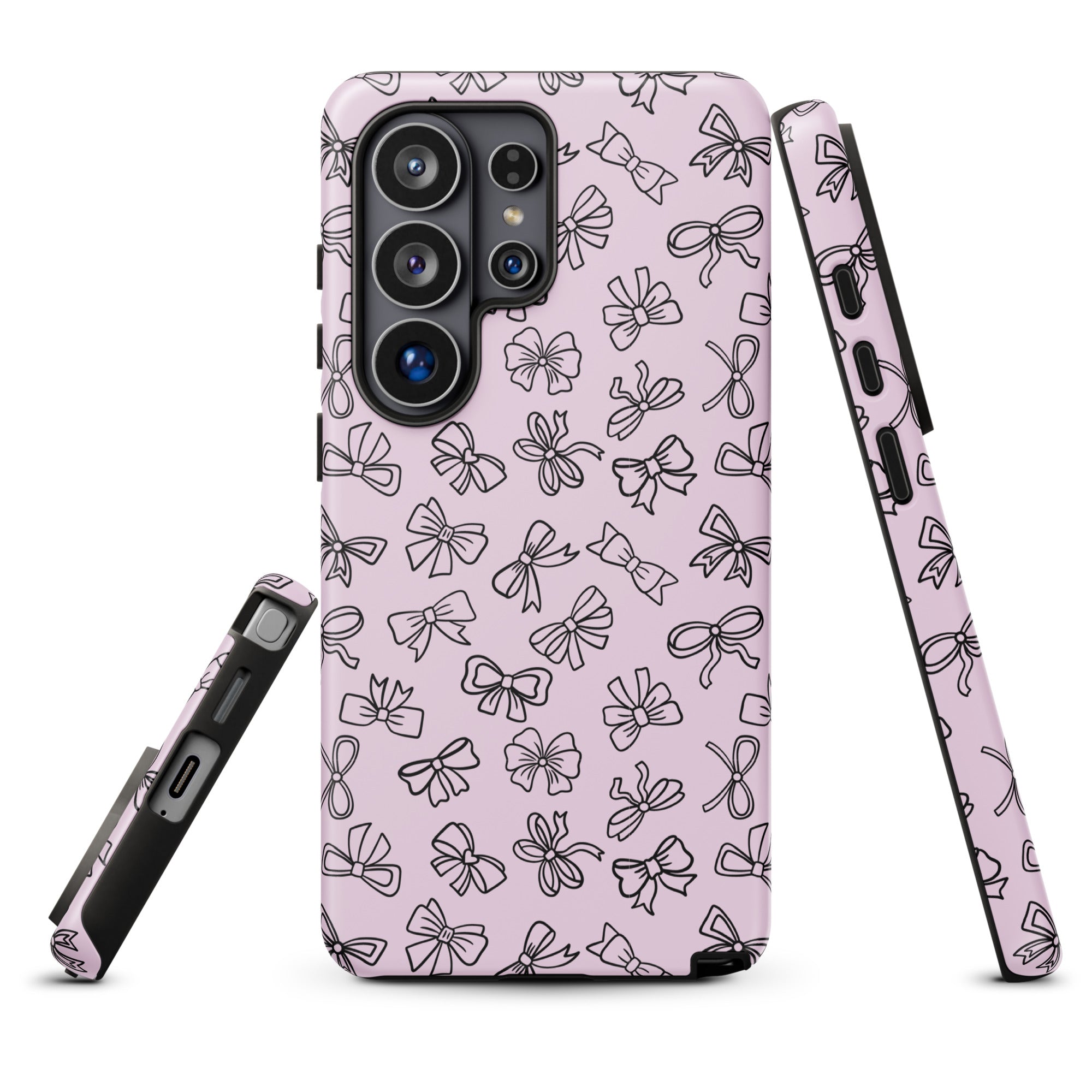a pink phone case with a repeating pattern of black bows on it.