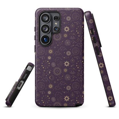 a purple phone case with a gold pattern of stars, planets, and other celestial elements.