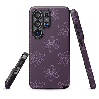 a purple phone case with a floral pattern and eyes resembling all seeing eye.