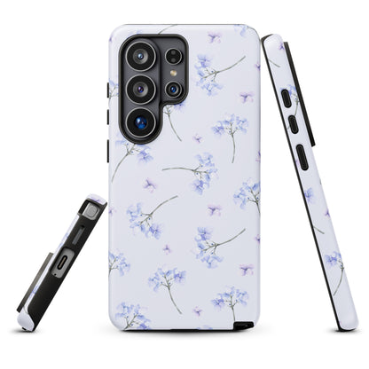a white phone case with a floral pattern, including blue flowers and stems.