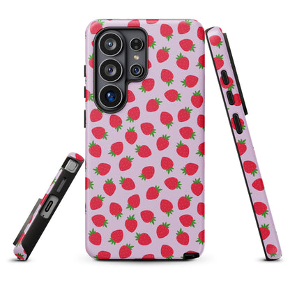 a pink phone case with a repeating pattern of red strawberries on a white background.